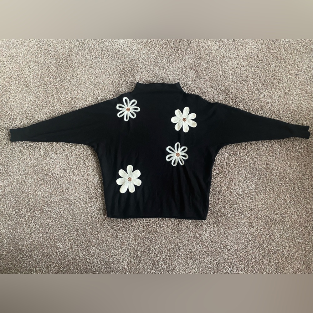 Black sweater with white flowers